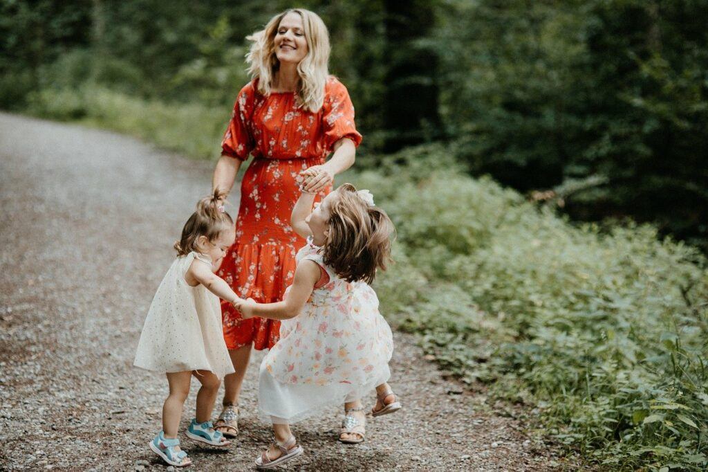 a woman and her small children dance as she considers therapy for parents