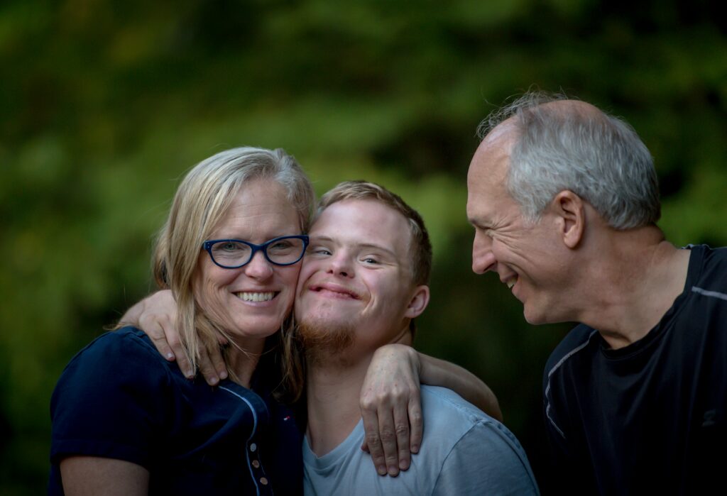 two parents and their son with down syndrome consider going to family therapy
