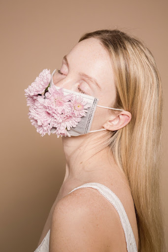 Peaceful woman in face mask experiencing holistic healing.