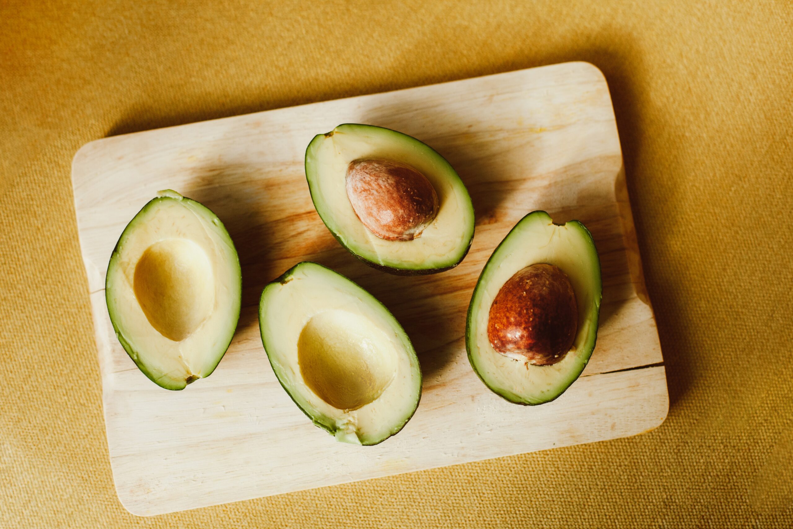 Close-up shot of Sliced Avocados on a Wooden Chopping Board