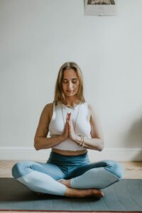 Woman Doing Yoga in A Room cultivating stress management and holistic healing