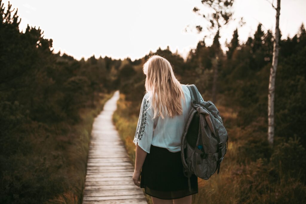 woman backpacking along a path in new jersey feeling lost in life