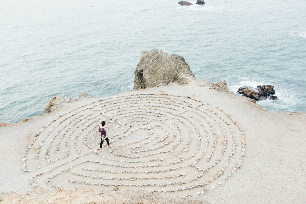 someone walking on a beach labyrinth in New Jersey discovering mind, body, and spirit connection and holistic healing