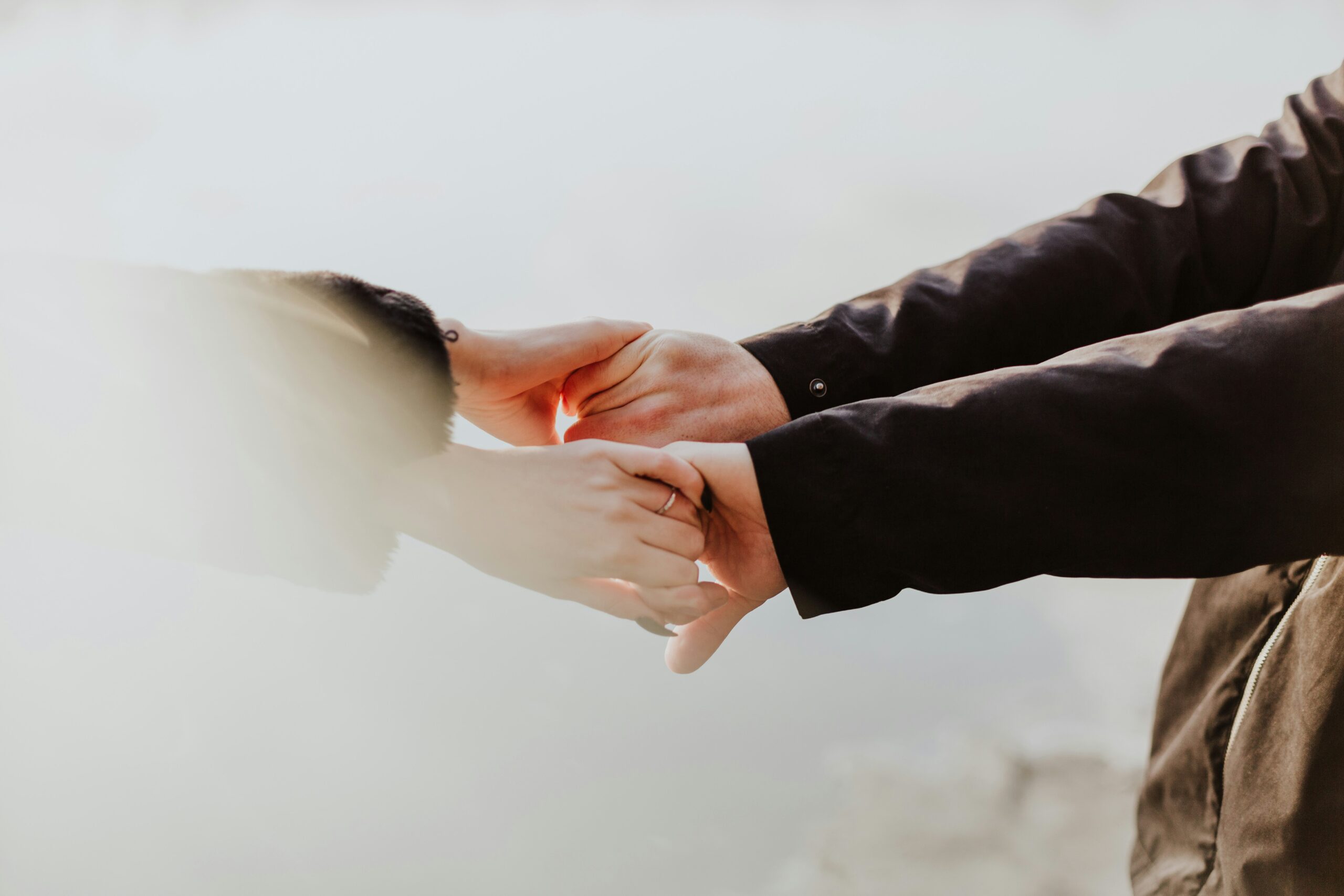 closeup of two people holding both hands