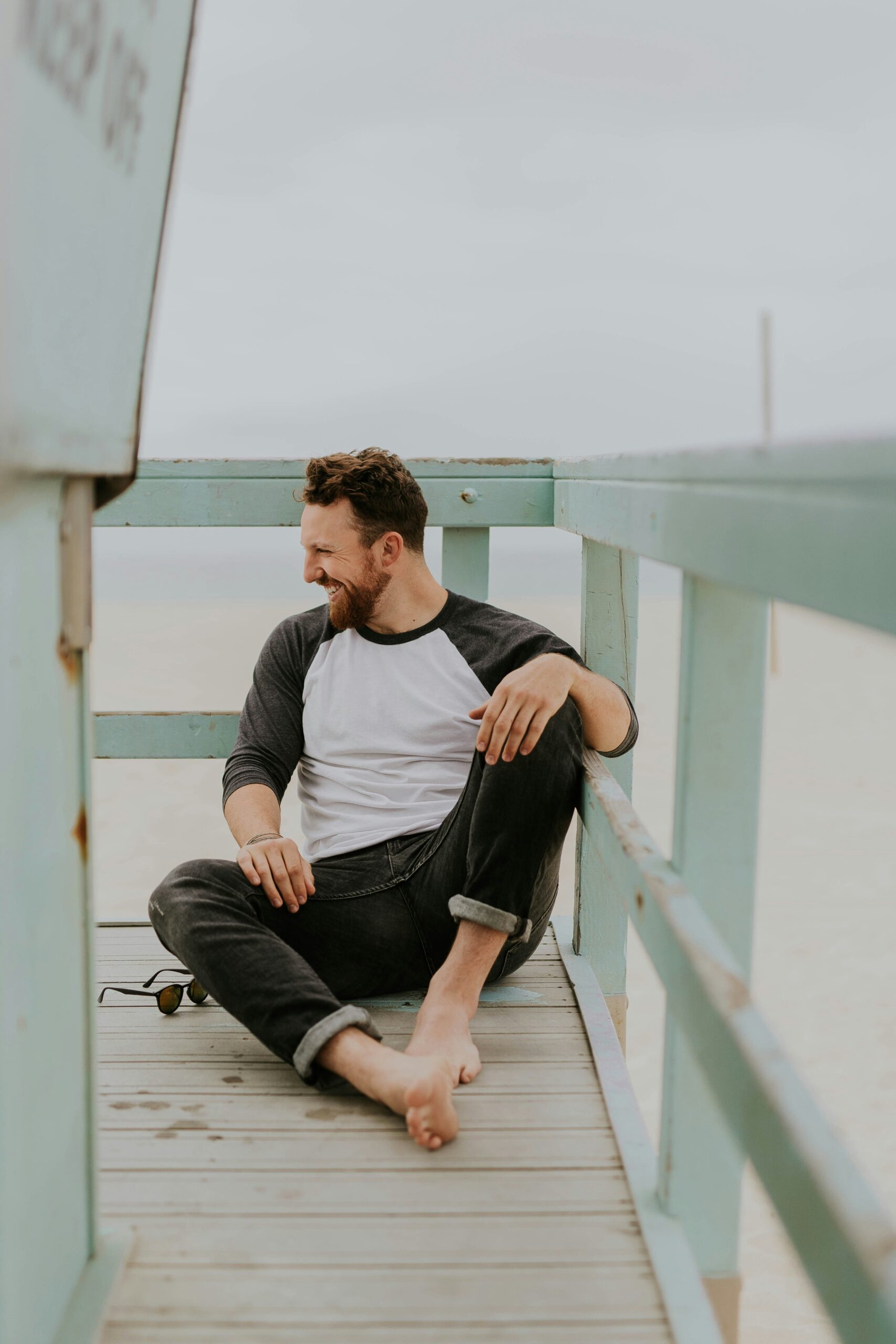 man smiling by the beach after overcoming social anxiety