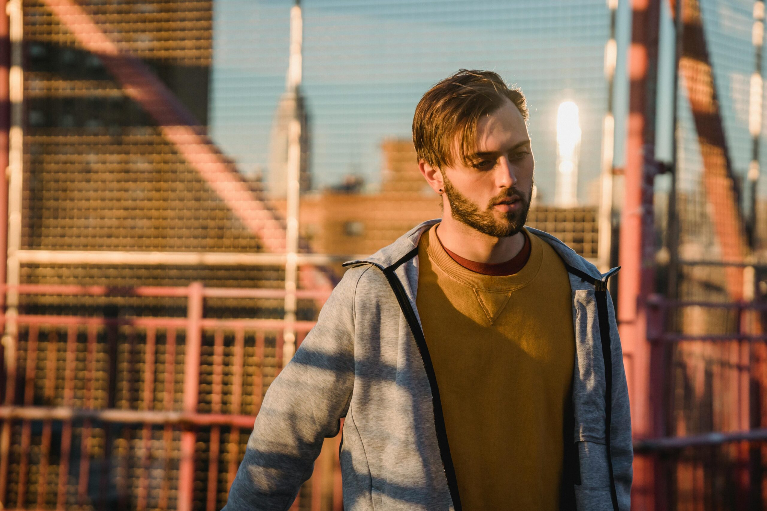 Young man walking alone in deep thought, representing relational grief, attachment wounds, and the experience of feeling misunderstood after betrayal.